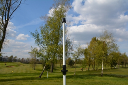 Golf flagpole spin system