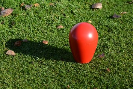 red pear shape plastic golf tee marker